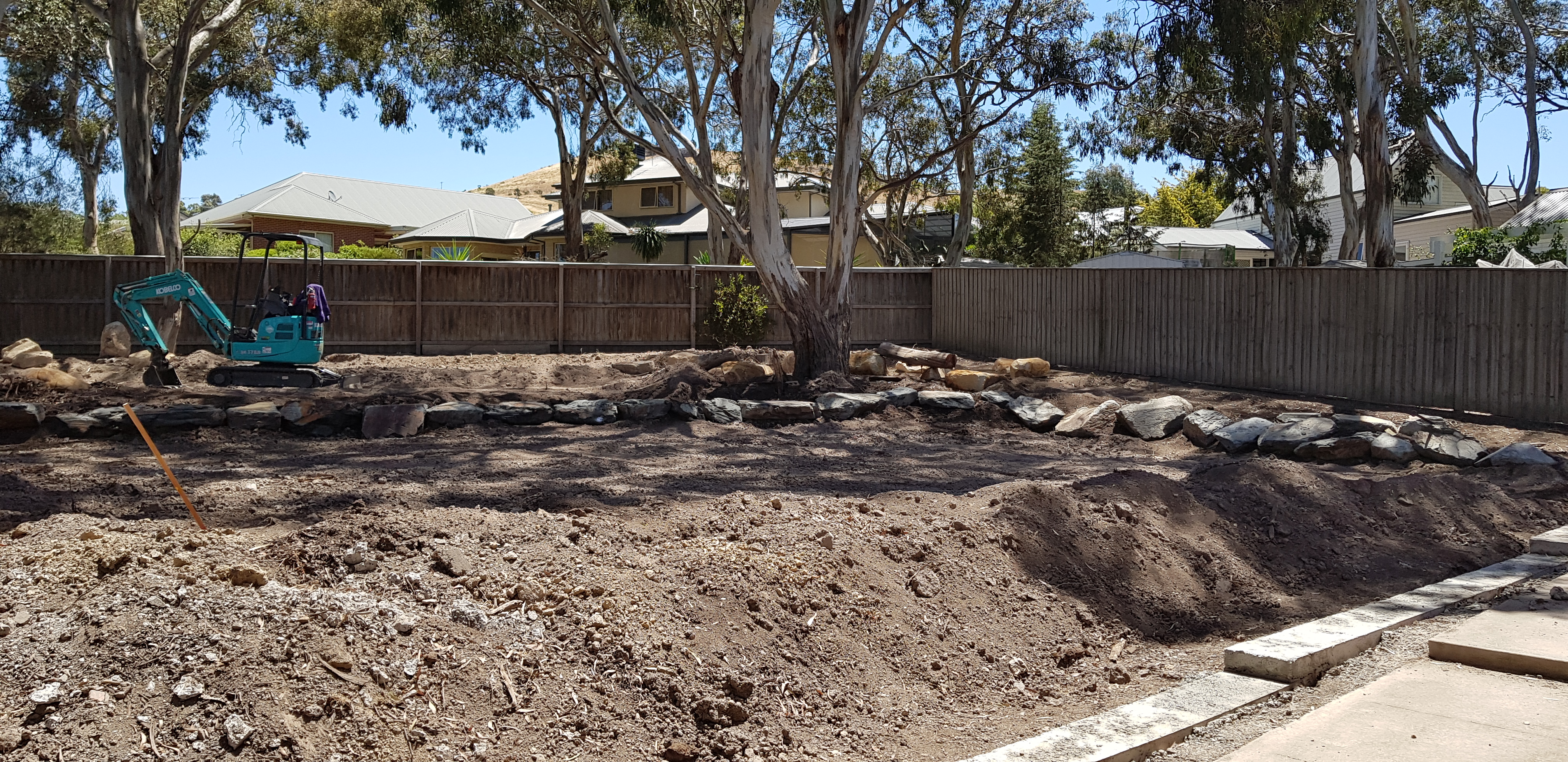 Before — bare dirt and excavation during ground levelling